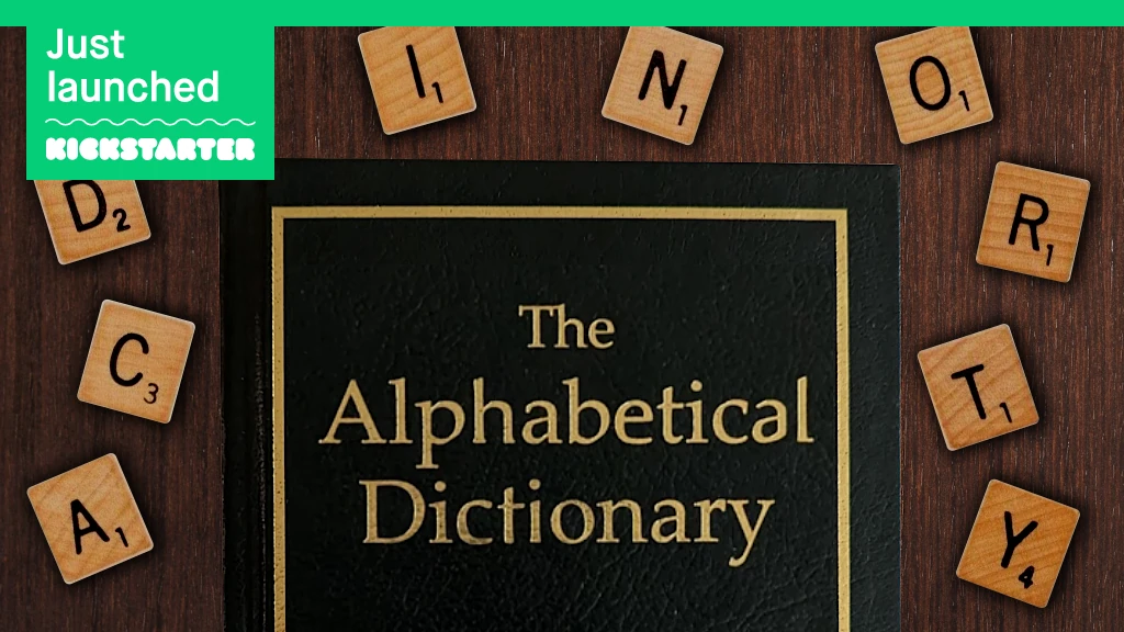 Green leather dictionary surrounded by Scrabble tiles