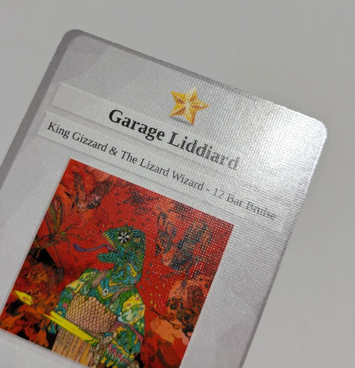 The front of a card with a linen texture. This card is Garage Liddiard from King Gizzard and the Lizard Wizard's 12 Bar Bruise