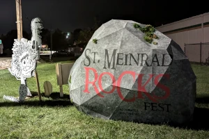 Large rock and character with guitar advertising St. Meinrad Rocks Fest